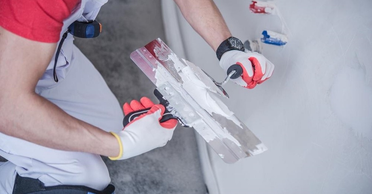 worker with drywall mud